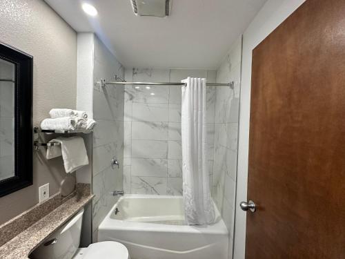 a bathroom with a shower and a tub and a toilet at Motel 6-Lebec, CA in Lebec