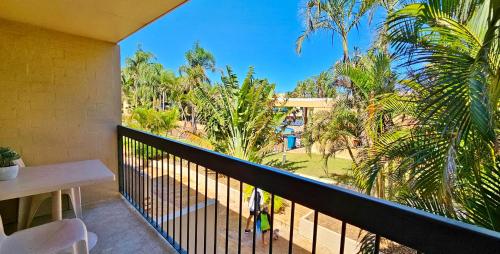 a balcony with a view of a park and palm trees at Riverview Holiday Apartment 112 - Kalbarri WA in Kalbarri