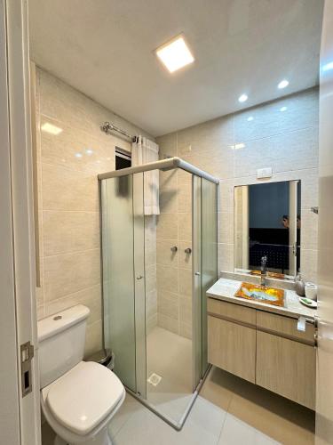 a bathroom with a shower and a toilet and a sink at Tropical Palace in Itapema