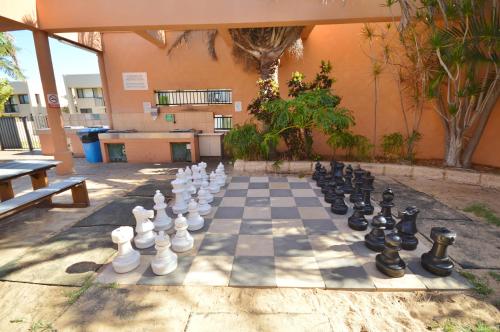 a chess board on the ground in front of a building at Riverview Holiday Apartment 112 - Kalbarri WA in Kalbarri