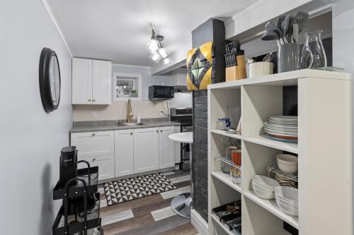 a kitchen with white cabinets and a sink at 7BR house 19 ppl DT Windsor WD Free Parking in Windsor