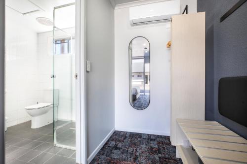a bathroom with a toilet and a mirror at Nightcap at Horse & Jockey Hotel Warwick in Warwick