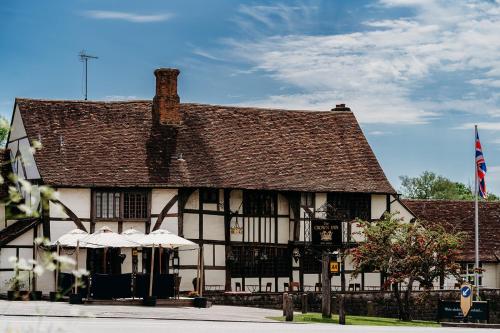 an old building with a brown and white building at The Crown Inn in Chiddingfold