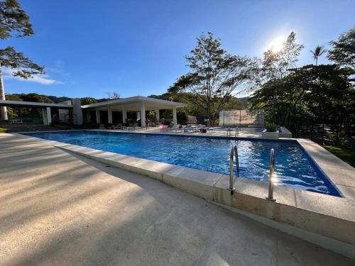 una piscina di fronte a una casa di Ocean View With Beach Club Access 12th Floor a Tárcoles