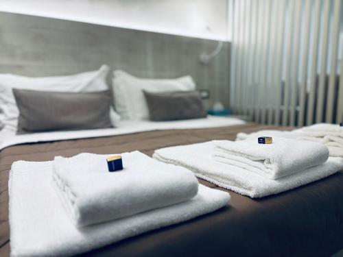 three white towels sitting on a table in a room at Appartamento - Angolo di Rio in Riomaggiore