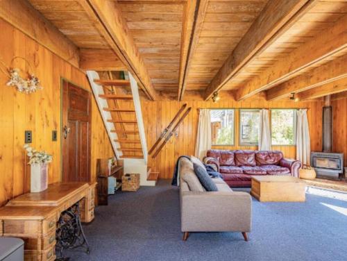 a living room with a couch and a table at Adventure Base in Ohakune