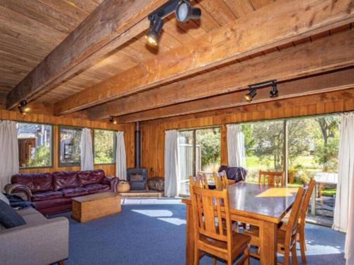 a living room with a table and a couch at Adventure Base in Ohakune