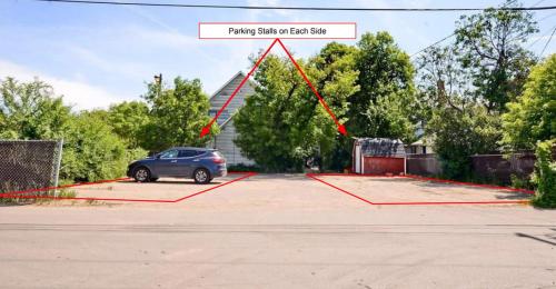 a car parked in a parking lot with a red triangle at Amazing DT Apartment w Parking Location Coffee in Moose Jaw