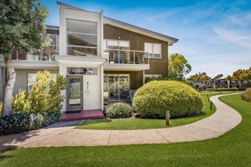 a house with a walkway in front of it at Ocean View at Silverwater in San Remo