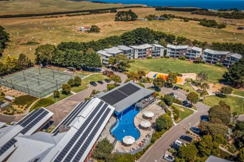 an aerial view of a resort with a pool and a tennis court at Ocean View at Silverwater in San Remo