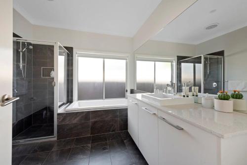 a white bathroom with two sinks and a shower at LUXURY SEASIDE RETREAT / SUSSEX INLET in Sussex inlet