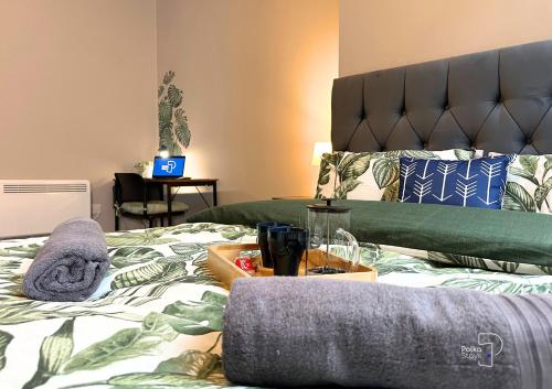 a bedroom with a bed with a green and white comforter at Hanley, Stoke - Modern Spacious Apartments by PolkaStays in Hanley