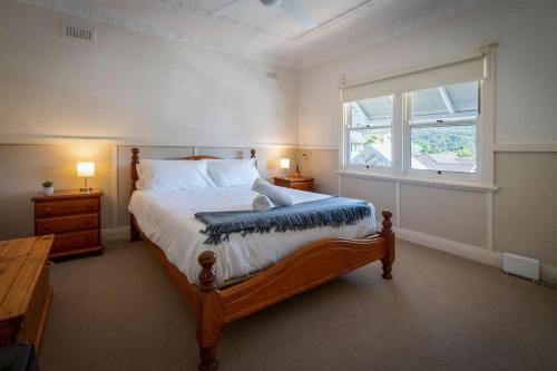 a bedroom with a large bed and a window at Blissful Beach Escape in Balgownie in Balgownie