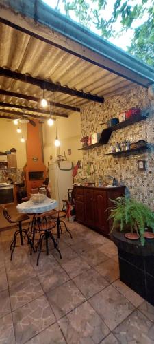 a kitchen with a table and a counter in a room at Quarto em casa familiar. in Porto Velho