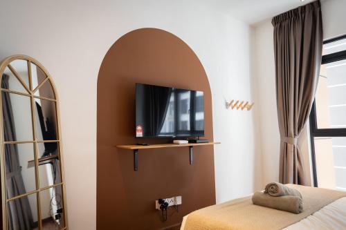 a bedroom with a mirror and a bed and a tv at K Avenue by Pinstay in Donggongon