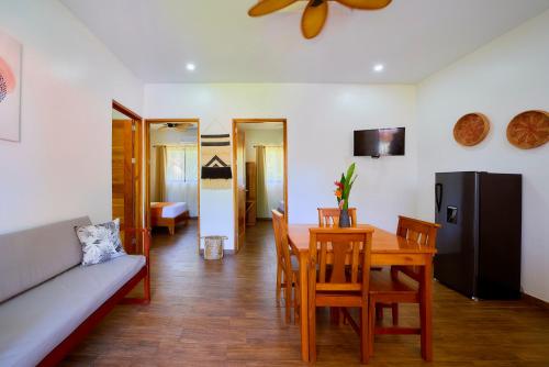 a living room with a table and a couch at Olinca Boutique Hotel in Puerto Viejo