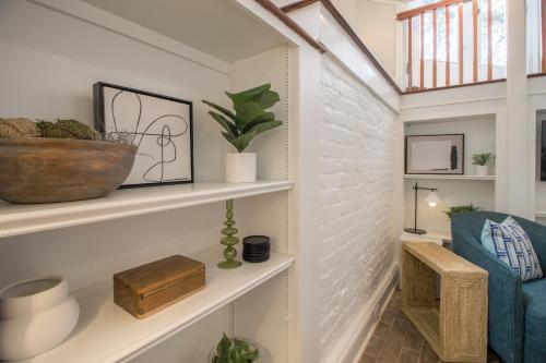 a room with white shelves with plants on them at Walk to it All in Downtown, Double King Beds in Savannah