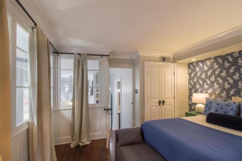 a bedroom with a blue bed and a window at Walk to it All in Downtown, Double King Beds in Savannah