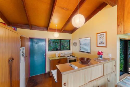 a kitchen with orange ceilings and a wooden counter at Lakeview Bush Hideaway - Pukawa Holiday Home in Kuratau