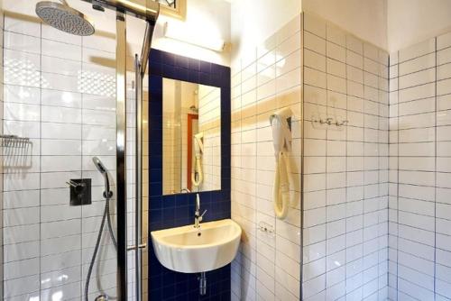 a bathroom with a sink and a shower at Hotel Miramare Et De La Ville in Rimini