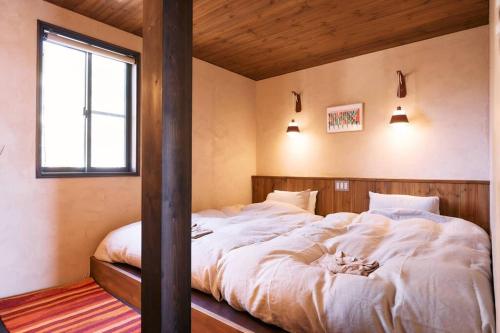 Postel nebo postele na pokoji v ubytování 一棟貸しVilla「nagare」