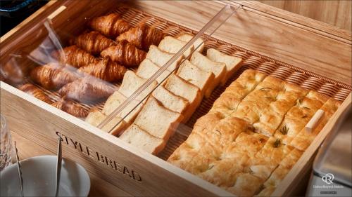 a wooden box filled with different types of bread at Daiwa Roynet Hotel Shimbashi in Tokyo
