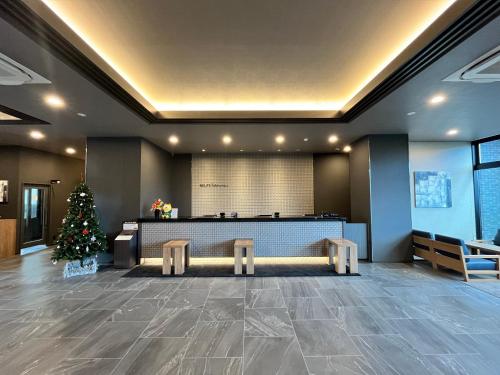 a lobby with a christmas tree in the center at Hotel Route Inn Miyakonojo in Miyakonozyō