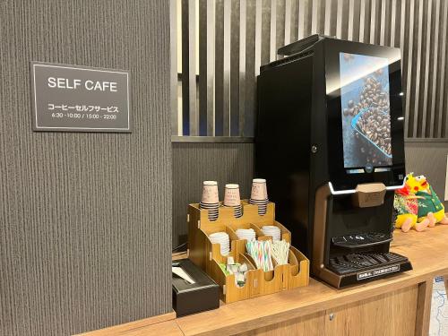 a coffee machine sitting on a counter in a store at Hotel Route Inn Miyakonojo in Miyakonozyō