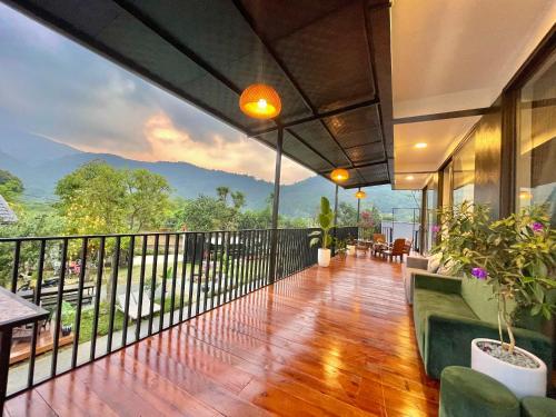 a house with a balcony with a view of the mountains at T House - Venuestay in Ba Vì