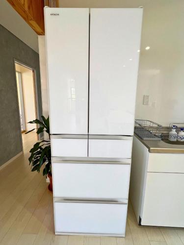 a white refrigerator in a kitchen with a counter at HOJO Brewing & Stays in Hōjō