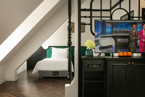a bedroom with a bed and a tv at Elegant Boutique Hotel Ha Long in Ha Long