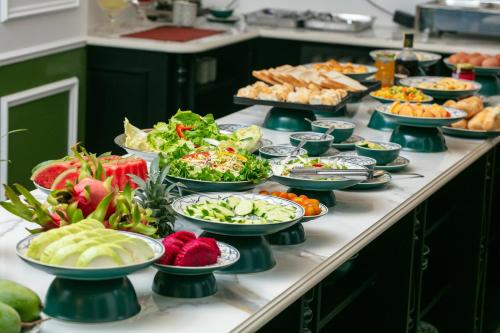 a buffet with many plates of food on a table at Elegant Boutique Hotel Ha Long in Ha Long