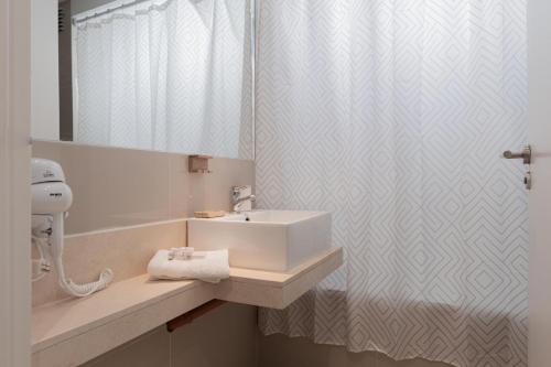 a bathroom with a sink and a shower curtain at Segui 3900 'b' - Loft Palermo Chico in Buenos Aires
