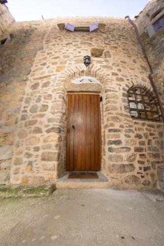 a brick building with a wooden door in it at Byzantine Home in the Castle in Mesta