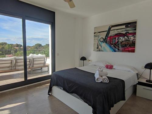 a bedroom with a bed and a large window at Casa Caldes de Malavella, 4 dormitorios, 8 personas - ES-209-82 in Caldes de Malavella