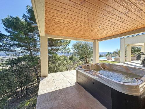 a jacuzzi tub on a patio with a view at Maison Manosque, 4 pièces, 6 personnes - FR-1-752-5 in Manosque
