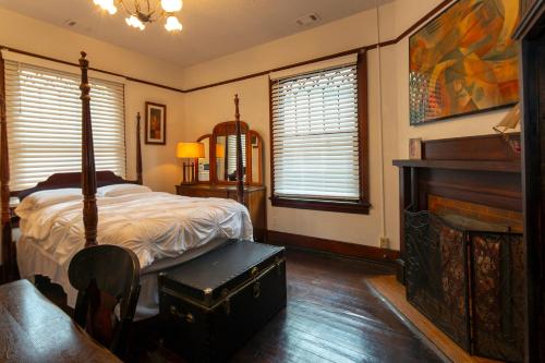 a bedroom with a bed and a piano at 5 BR Downtown Savannah GA in Savannah