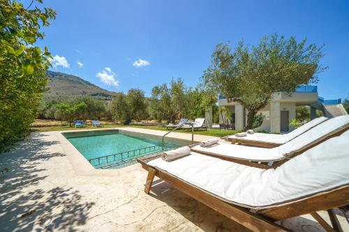 a villa with a swimming pool and two beds at Villa Marian with Private Swimming Pool & Jacuzzi in Georgioupolis