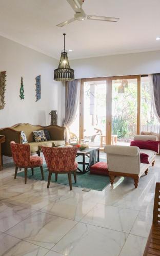 a living room with a couch and a table at Villa Gardenia Pantai Jepara in Jepara