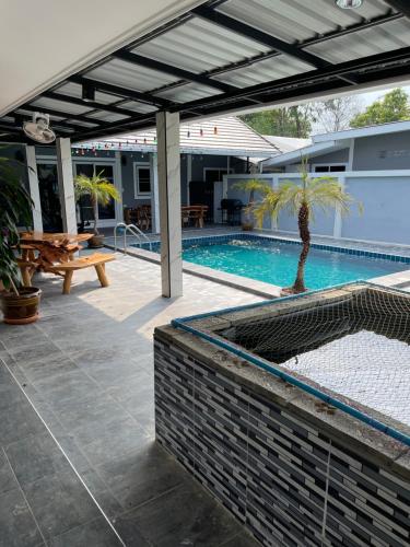 a patio with a swimming pool with a pergola at S & K surin in Ban Khi Lek