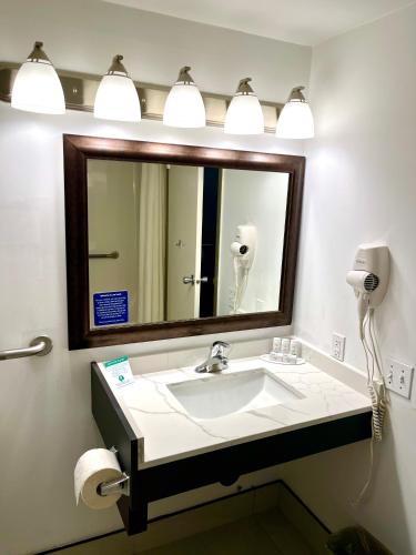 a bathroom with a sink and a mirror at Super 8 by Wyndham Hinton in Hinton