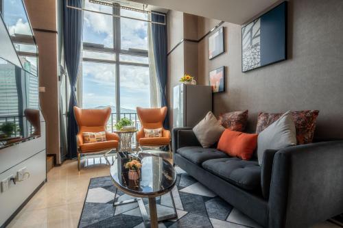 a living room with a couch and a table at Zun Xiang Executive Apartment - Shenzhen Futian Exhibition Center in Shenzhen