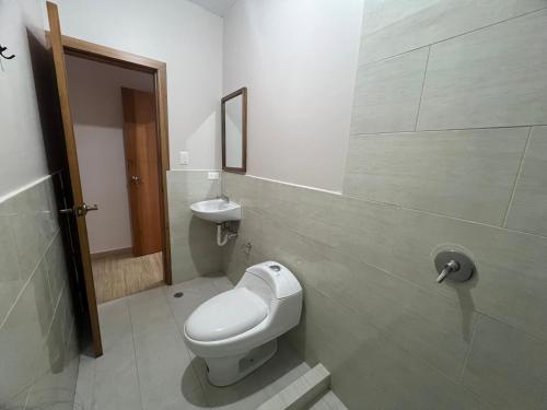 a bathroom with a toilet and a sink at Hostal Paraíso de Los Andes in Riobamba