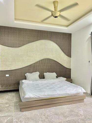a bedroom with a bed with a large headboard at AKIRA VILLA _ Venuestay in Ba Vì