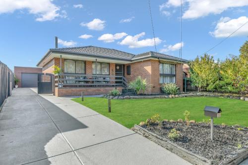 a brick house with a lawn in front of it at Melbourne Airport Pet friendly Guest House in Melbourne