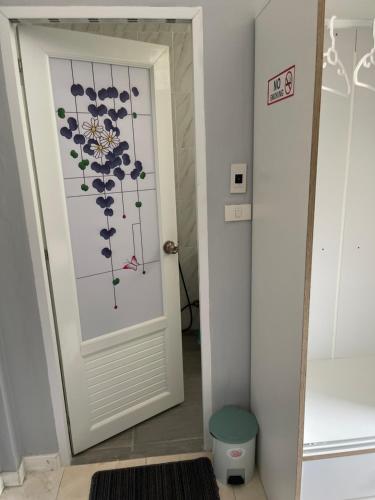 a door with a flower on it in a hallway at S & K surin in Ban Khi Lek