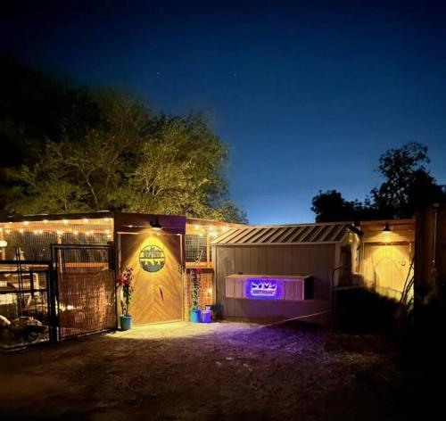 a garage with a sign on the side of it at night at Matchbox desert oasis hot tub, pet friendly! in Las Cruces