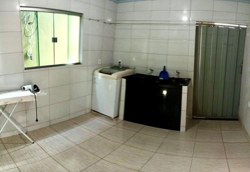 a bathroom with a sink and a shower in it at Recanto da Chapada in Alto Paraíso de Goiás