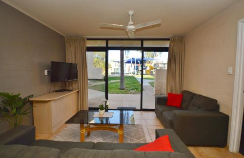 a living room with a couch and a tv at Riverview Holiday Apartment 28 - Kalbarri WA in Kalbarri