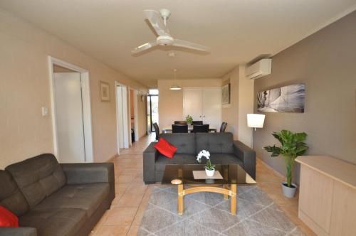 a living room with a couch and a table at Riverview Holiday Apartment 28 - Kalbarri WA in Kalbarri